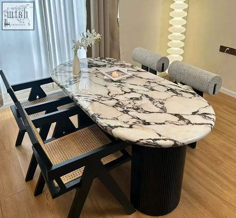 Elegant amina oval dining table with white and black marble top and black ribbed pedestal base for dining room