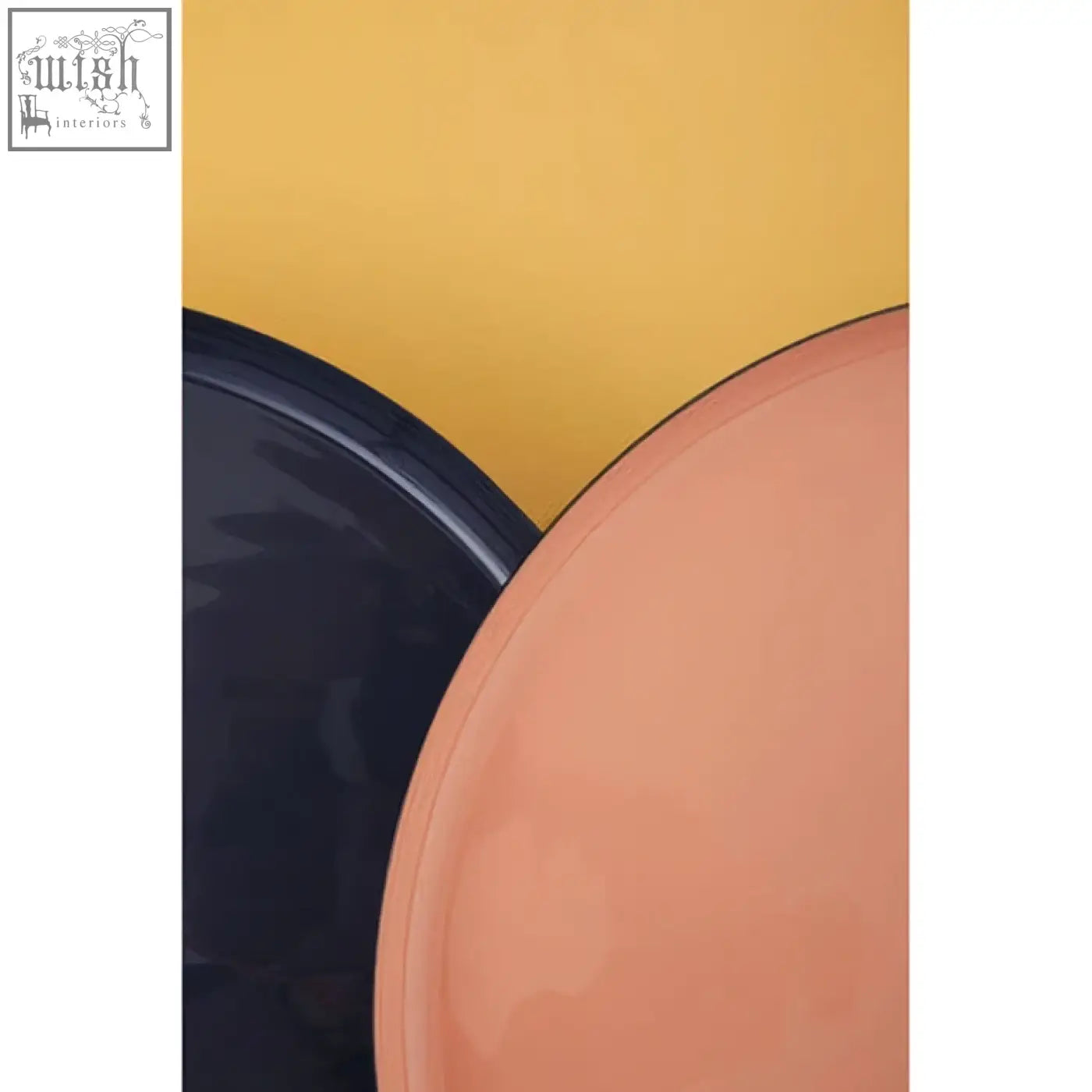 A sleek peach and dark navy plate highlight the amira set of three gold and black tray tables against yellow background