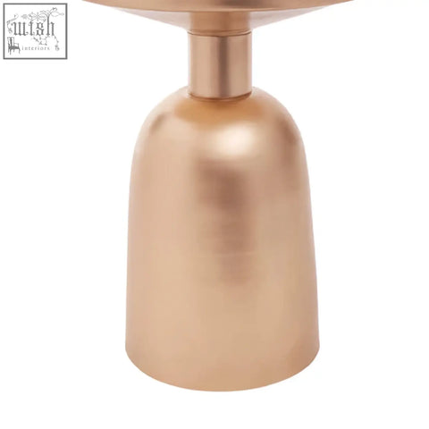 A sleek amira white marble top side table with a copper-toned bell-shaped metal base and flat circular top