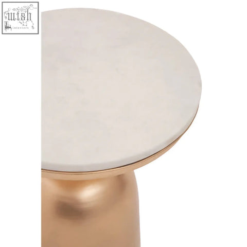 A sleek amira white marble top side table with a round white marble surface and gold-toned metal pedestal base