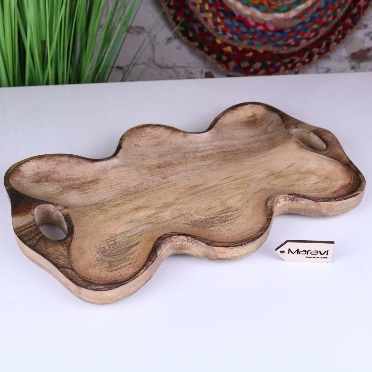 Natural mango wood serving dish with organic shape and two hand carved handles perfect for wood serving