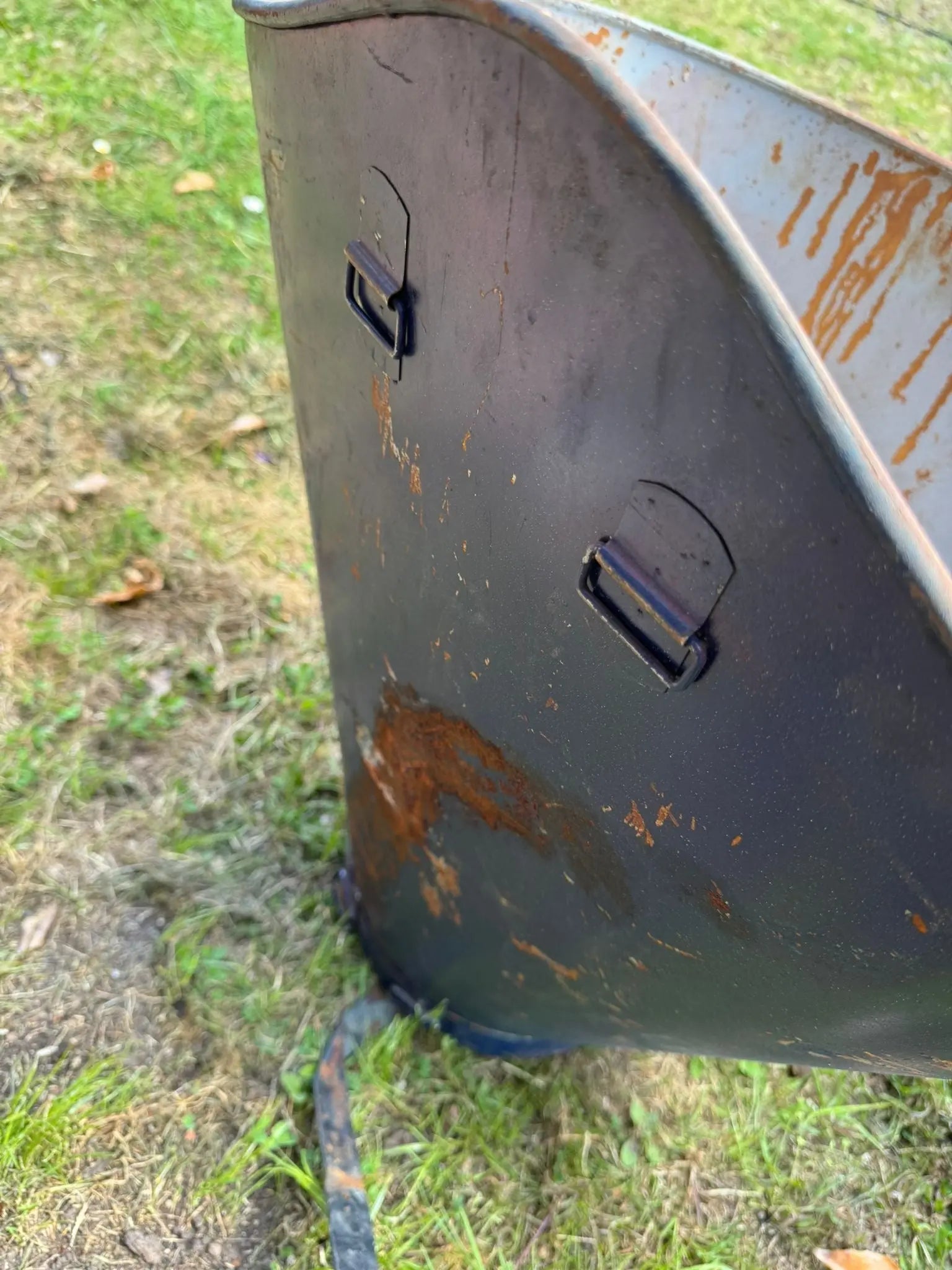 Rusty black metal trash can with two handle latches from an antique pair vintage french grape hod log basket planters