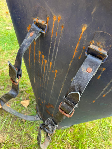 Black leather straps with rusted buckles on a dark weathered antique vintage french grape hod planter