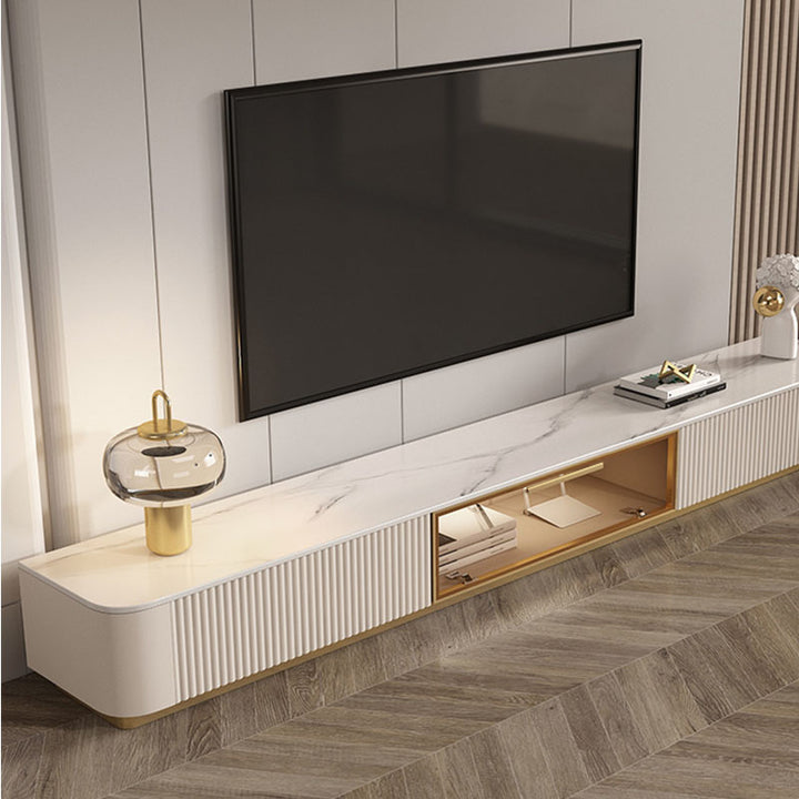 Modern white marble-top anastasia tv stand with gold-trimmed grooves and open shelving made of sintered stone