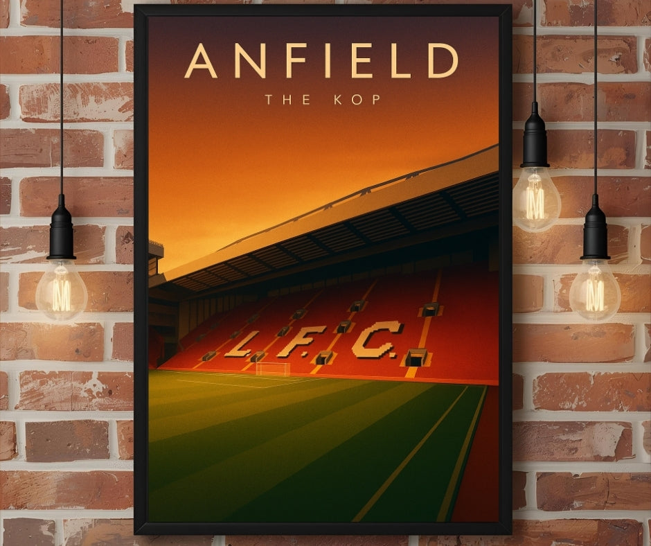 A framed stadium wall art of anfield the kop with gold lettering above vibrant orange and green lfc field