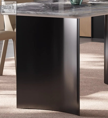 Black curved metal leg of angela marble dining table with sleek modern design for luxury dining setup