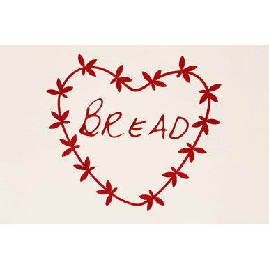 Red heart shaped sticker with bread cursive on anglaise bread bin outlined by decorative vine pattern