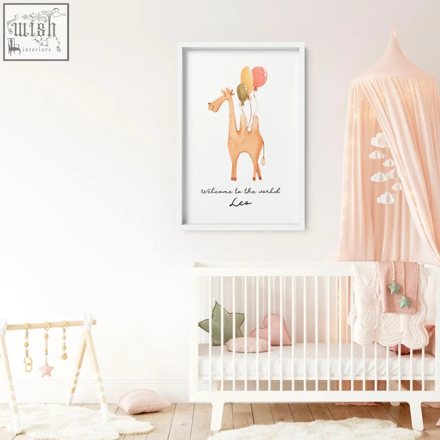 A framed watercolor animal print of a tan giraffe holding colorful balloons for nursery decor with welcome text