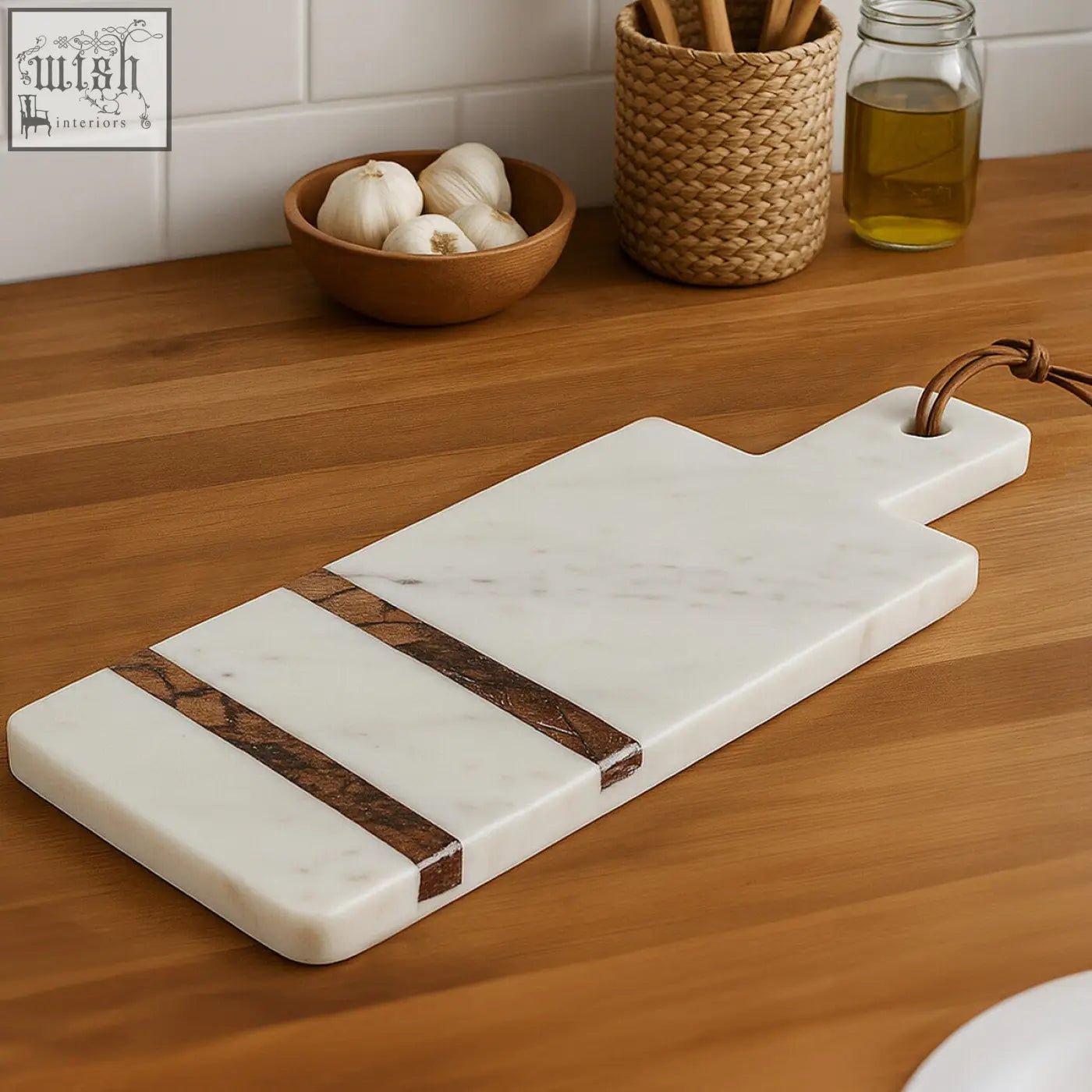 A sleek white marble paddle board with brown forest marble inlays and leather loop handle for easy hanging