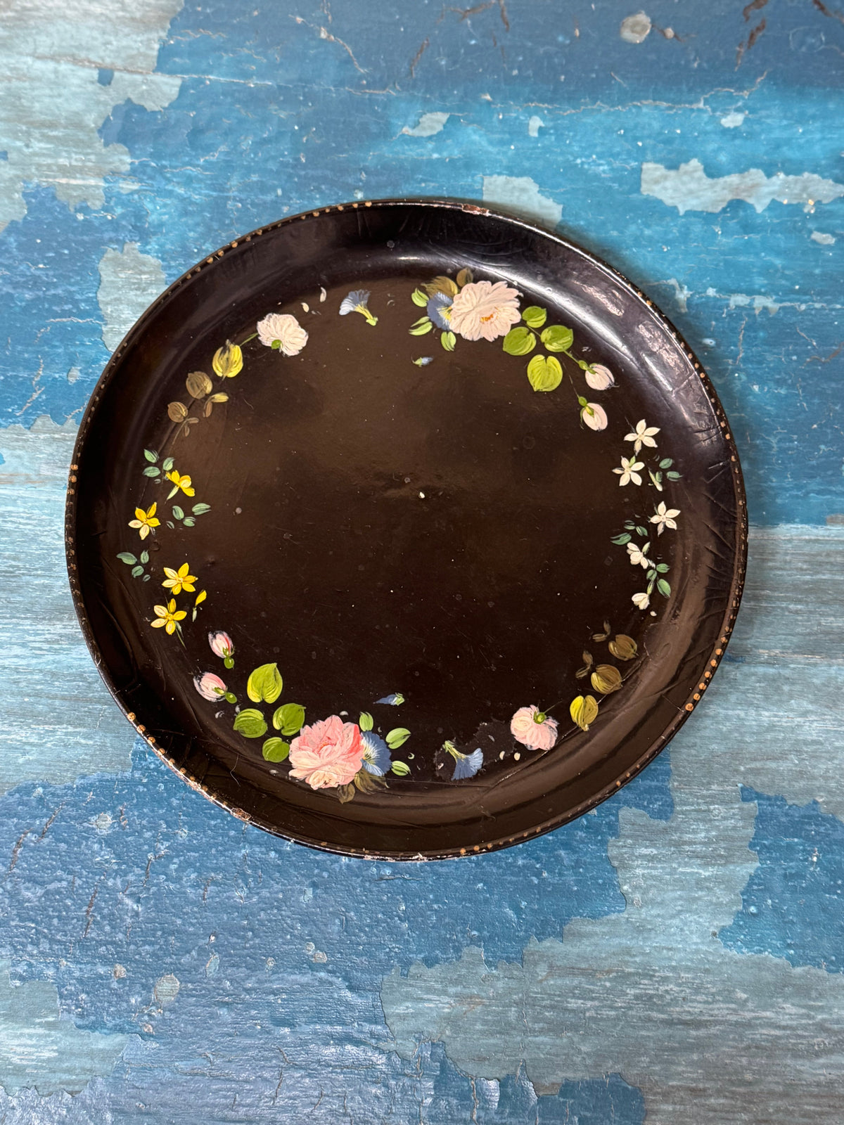 Dark brown ceramic plate tray with delicate pink white yellow floral border on black lacquer chinoisserie design