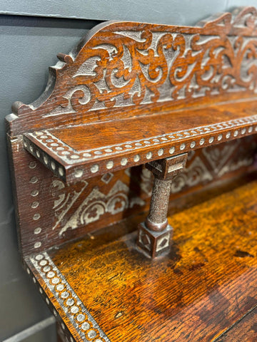 Antique carved oak hall table with intricate scrollwork and inlaid details as an oak hall table or sideboard