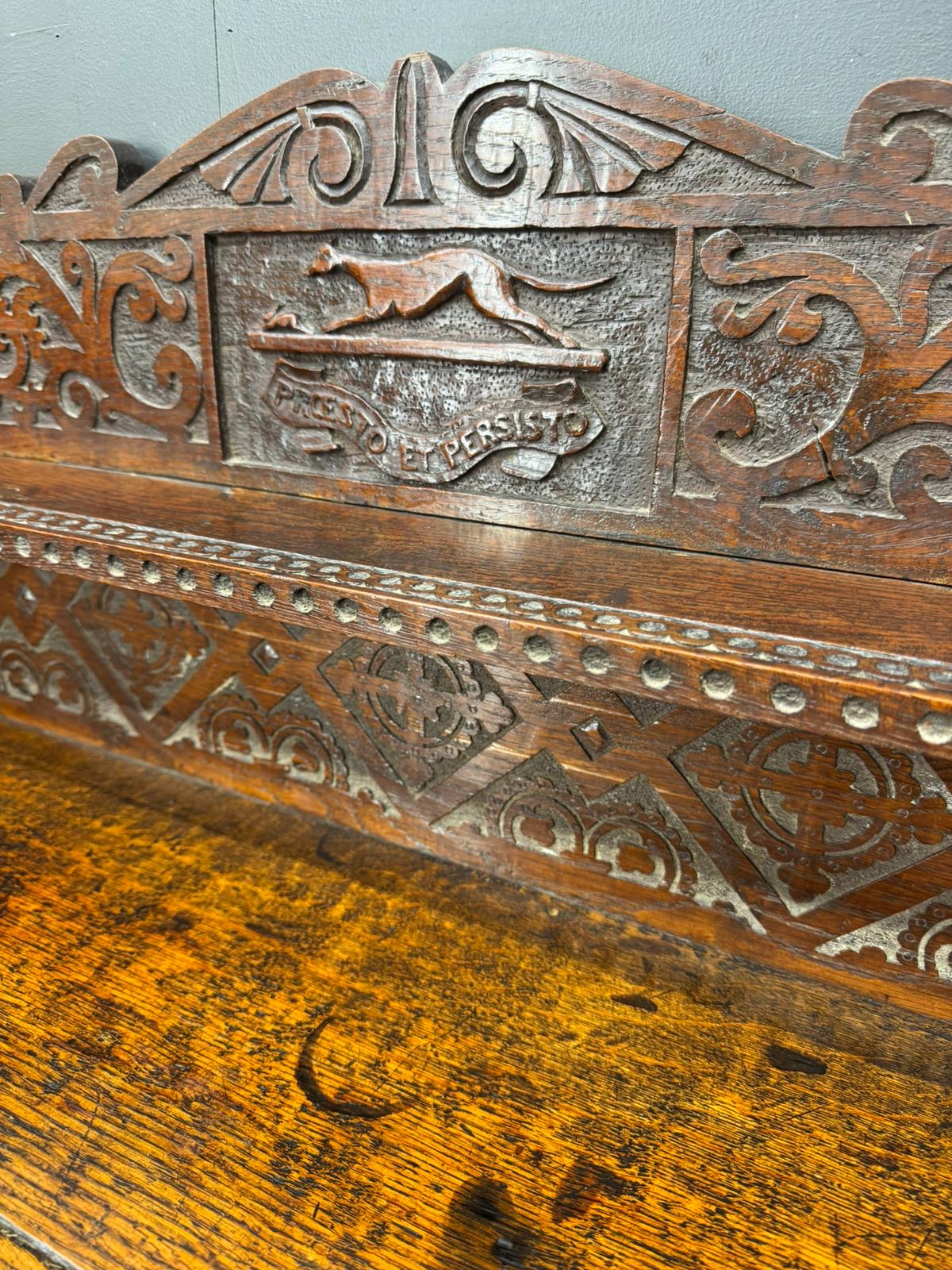 Antique carved oak hall table bench in dark wood with intricate animal relief and freedom persists inscription