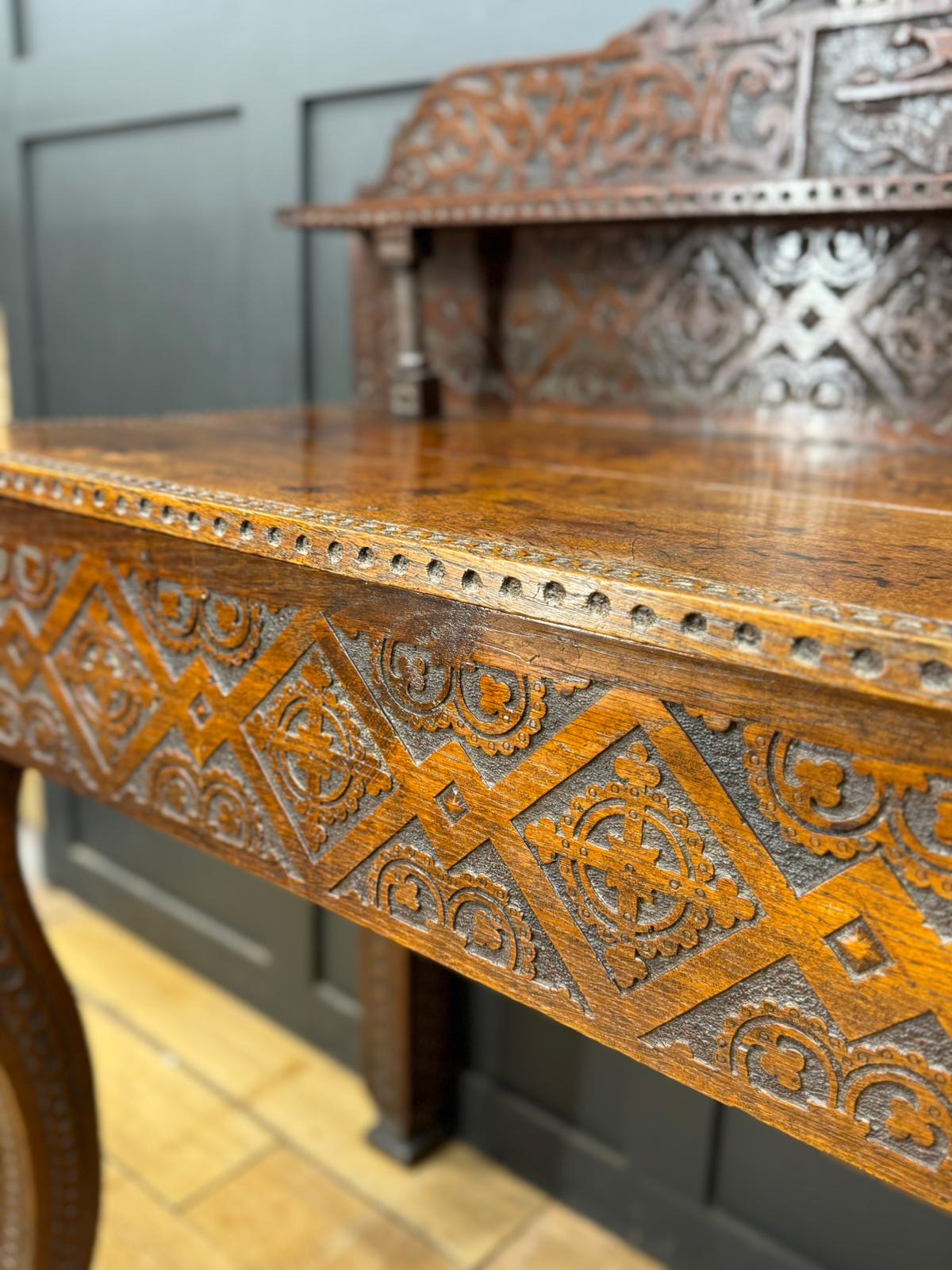 Antique anglo-indian carved oak hall table with intricate carvings and warm polished finish oak hall table