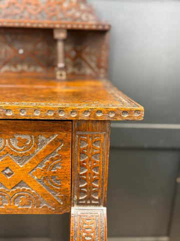 Antique carved oak hall table with intricate geometric and floral inlays in warm amber wood finish ideal as hall table