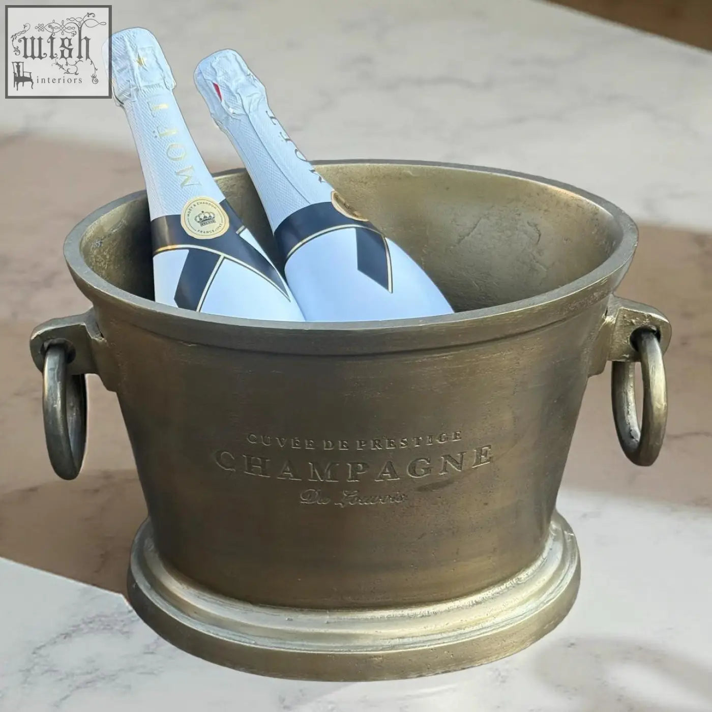 Antique brass solid cast engraved champagne ice bucket cooler with cuvée de prestige engraving and two blue moët bottles vintage french brasserie style