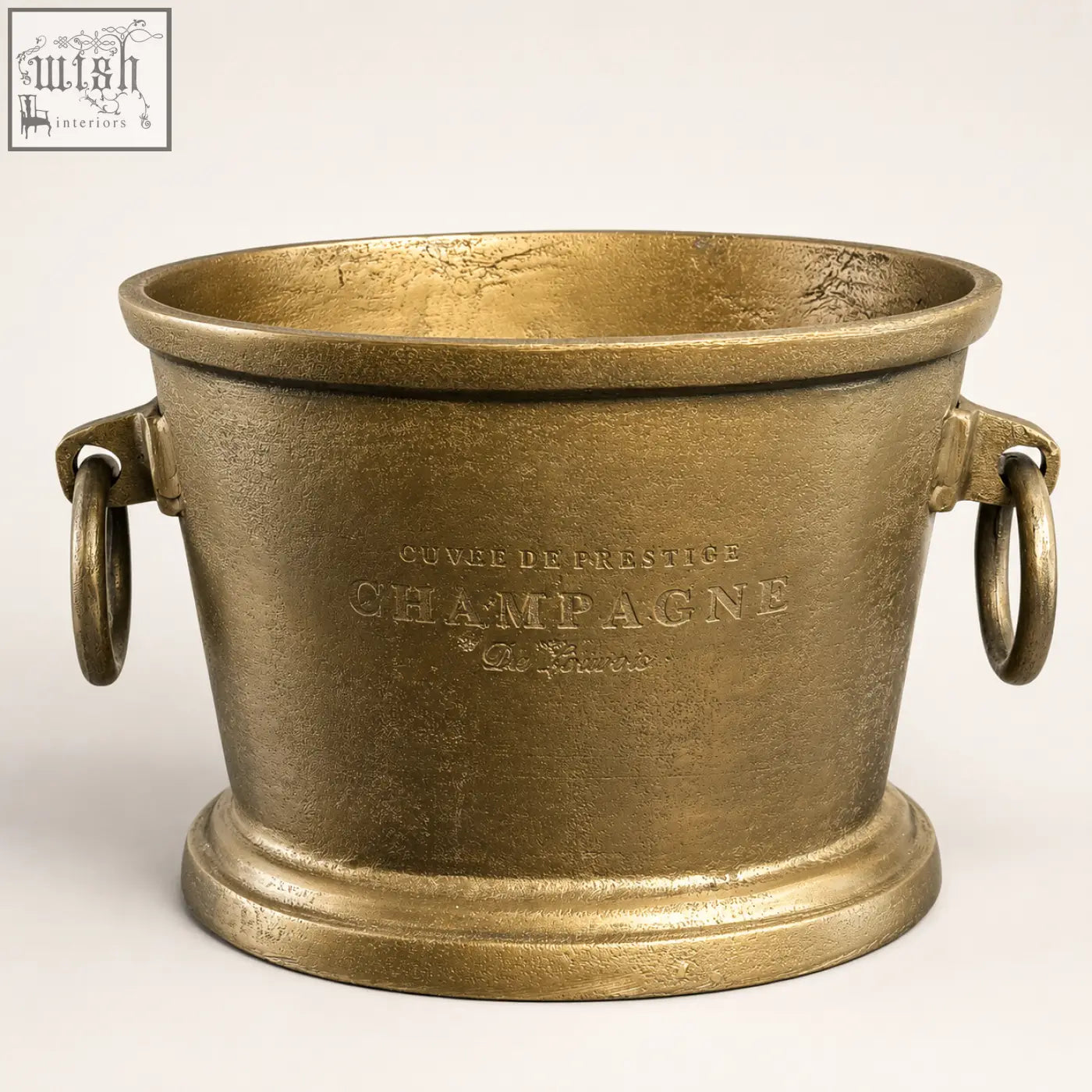 Antique brass solid cast champagne bucket cooler with gold finish and embossed cuvée de prestige text for vintage french brasserie style