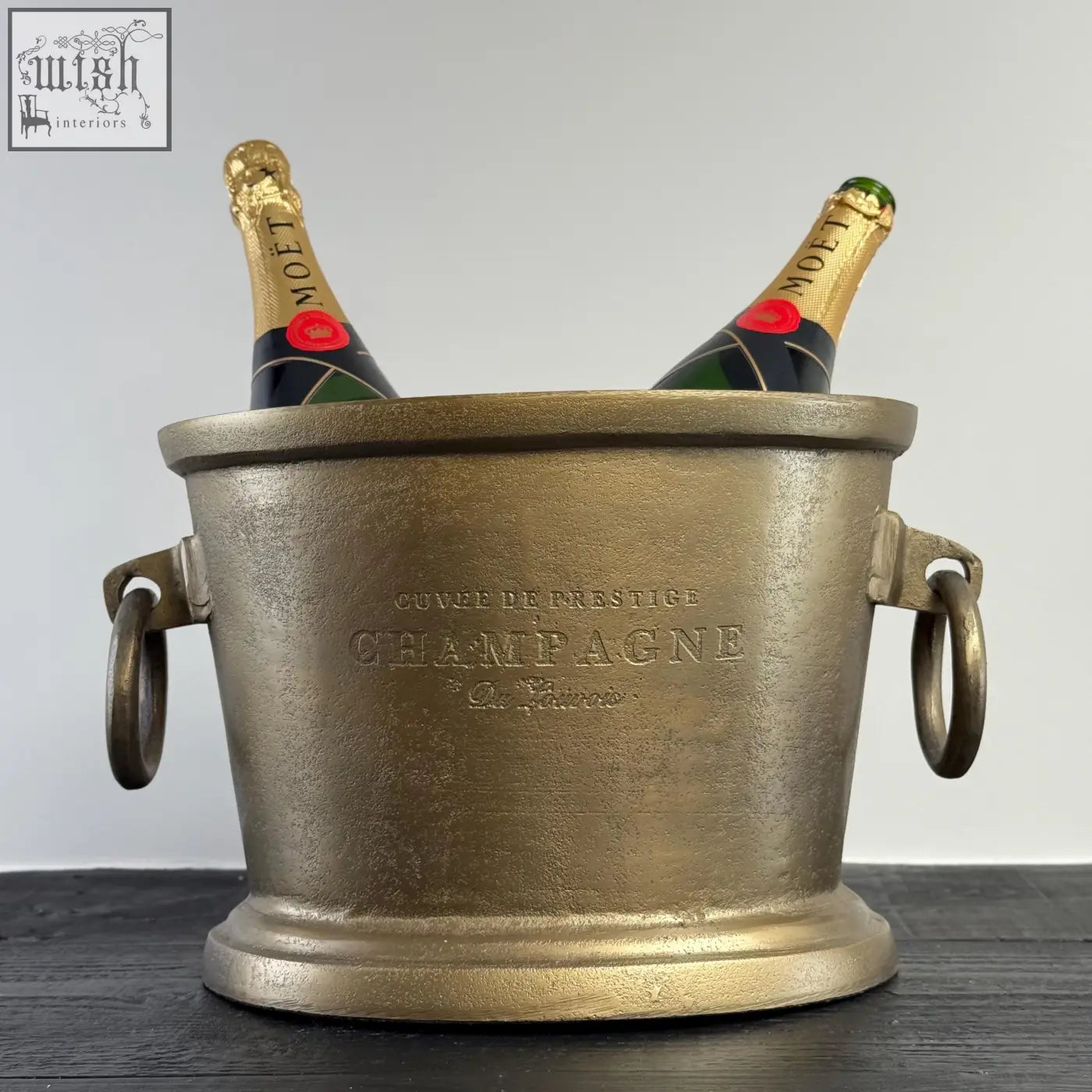 Gold-finished antique brass solid cast engraved champagne ice bucket with ring handles holding two moët bottles, vintage french brasserie style