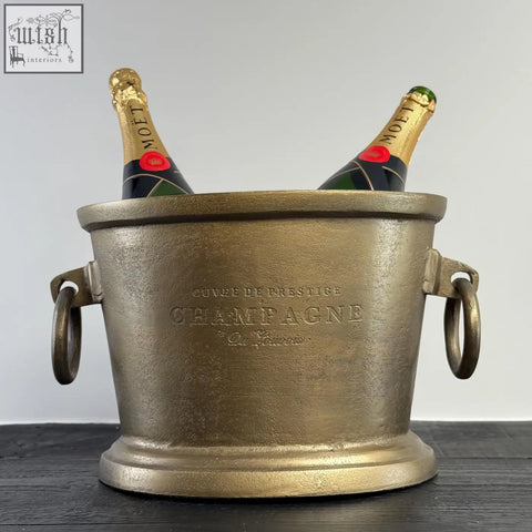 Gold-finished antique brass solid cast engraved champagne ice bucket with ring handles holding two moët bottles, vintage french brasserie style