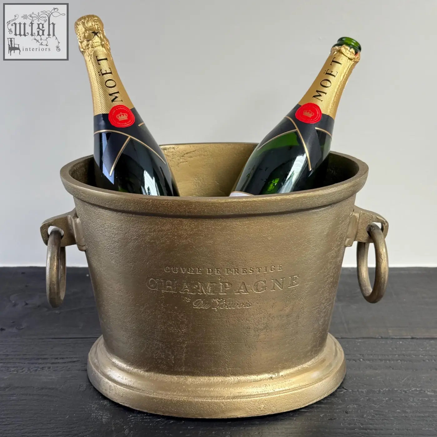 Gold-finished solid cast engraved champagne bucket with handles holding moët bottles perfect for vintage french brasserie style