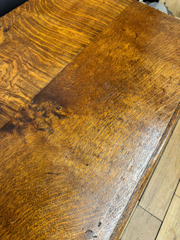 Rich amber finished antique carved oak side table surface with prominent grain patterns and natural knot for hall table