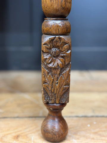 Antique carved oak side table leg with detailed floral design and warm brown finish for lamp or hall use