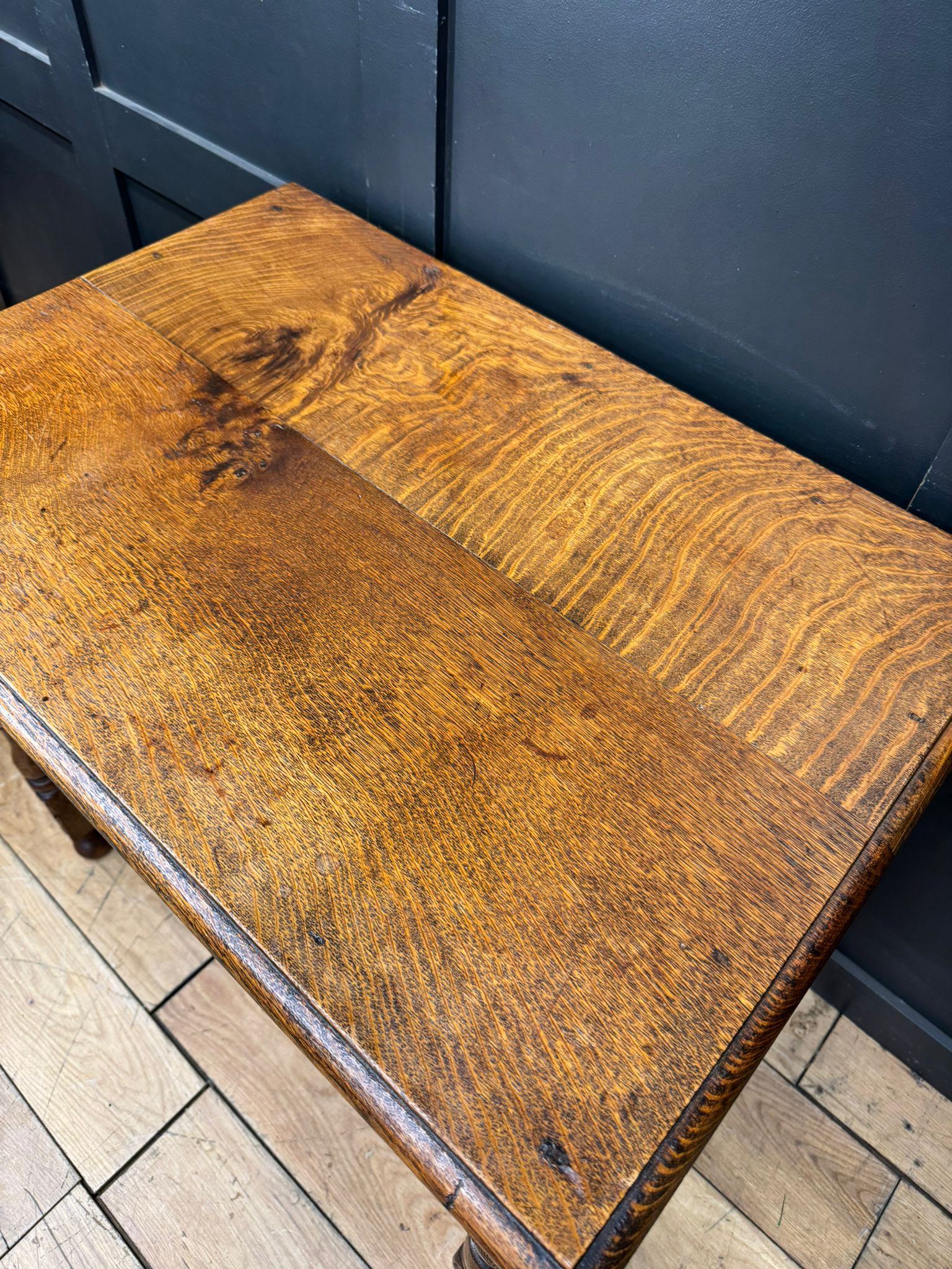 Antique carved oak side table with drawer in warm golden brown finish featuring natural wood grain patterns for hall use
