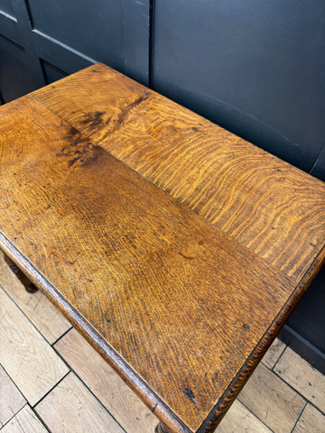 Antique carved oak side table with drawer in warm golden brown finish featuring natural wood grain patterns for hall use