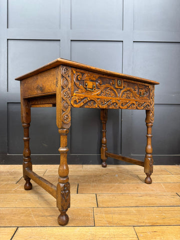 Antique carved oak side table with drawer featuring intricate carvings and turned legs perfect as a hall table