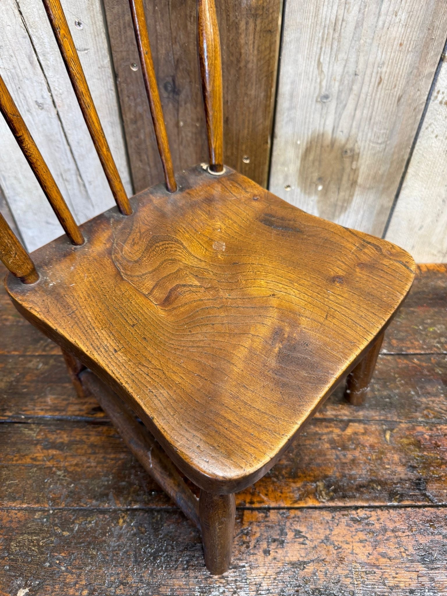 Antique child’s chair with elm seat made of oak and slender spindles perfect as nursery book display plant stand