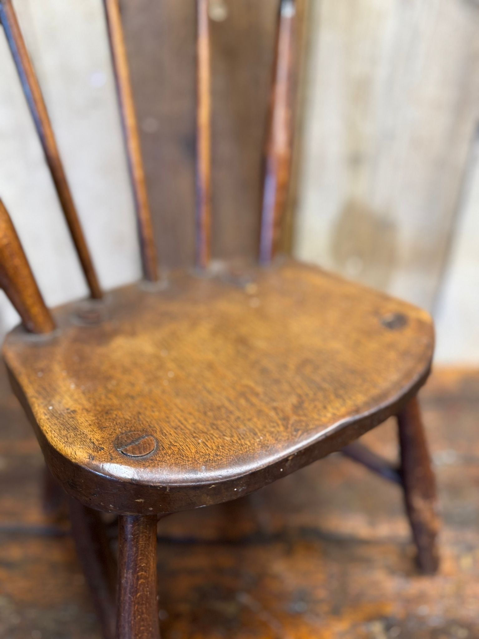 Antique dark wood windsor child’s chair with curved oak seat perfect for nursery book display or plant stand