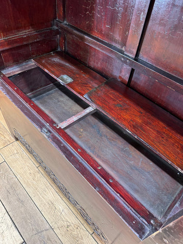 Antique chinese open wedding cabinet in reddish-brown wood with carved detailing and visible wear for display use