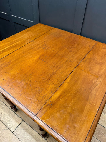 A warm amber finished mahogany antique extending pembroke table with drop leaf and smooth polished surface