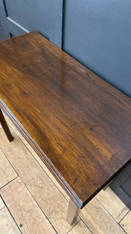 Antique extending mahogany tea table with polished dark brown wood and smooth reflective surface showing wood grain
