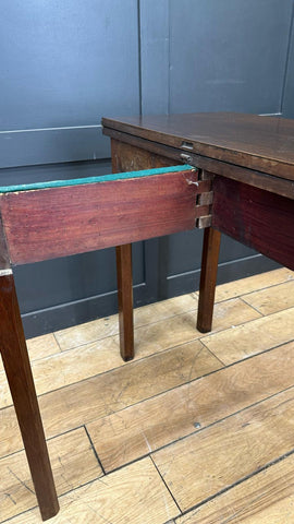 Antique extending mahogany tea table in dark wood with visible joinery and teal green felt underside