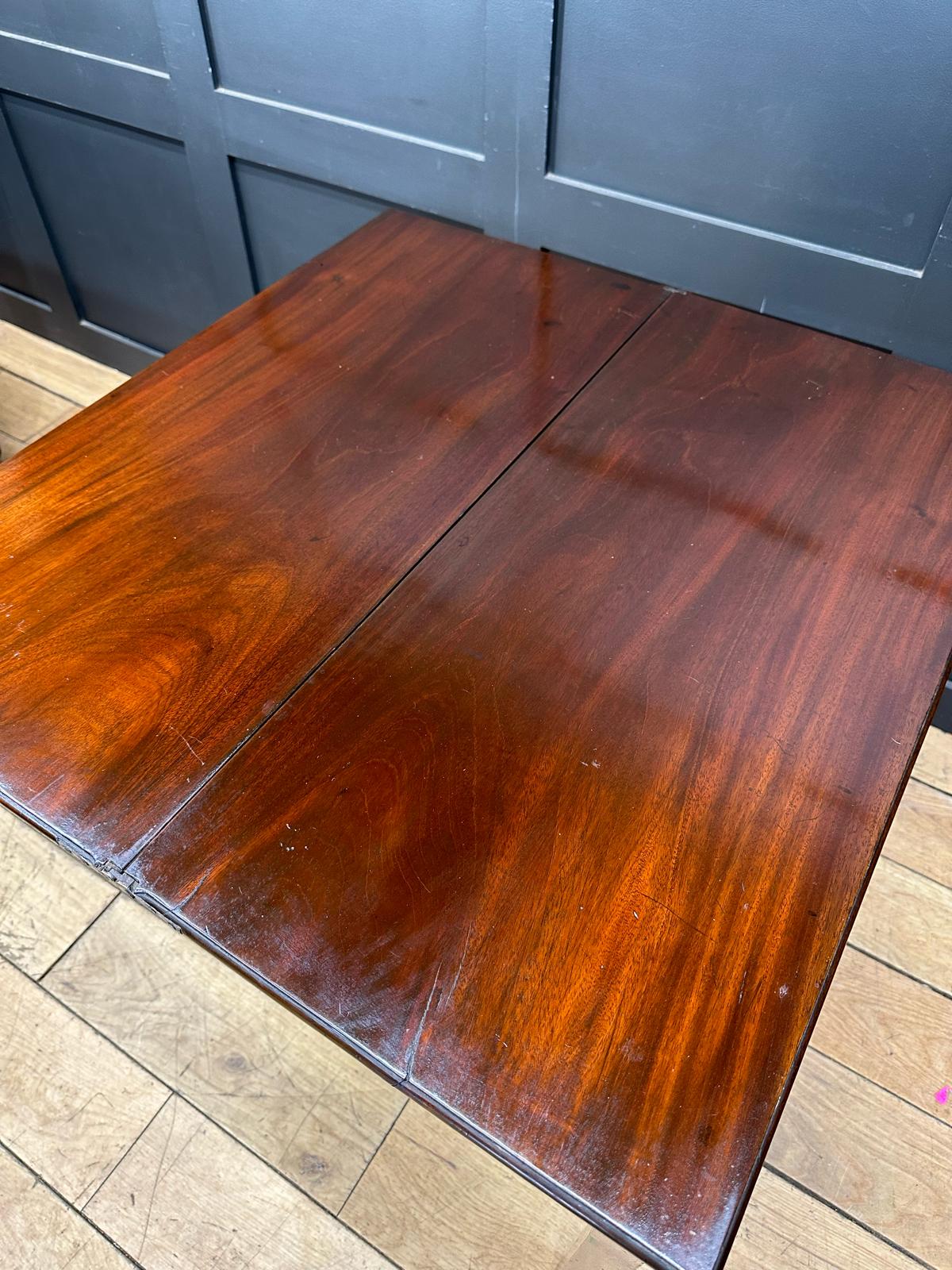 Rich mahogany tea table with glossy finish and visible wood grain perfect as antique extending game or occasional side table