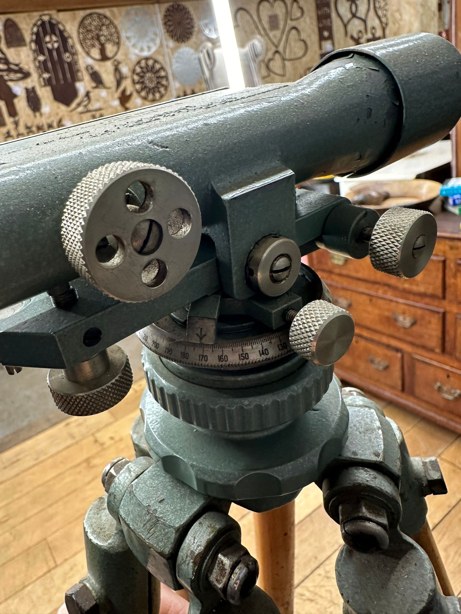 Vintage green metal antique hall brothers theodolite with textured knobs and graduated scale for surveying