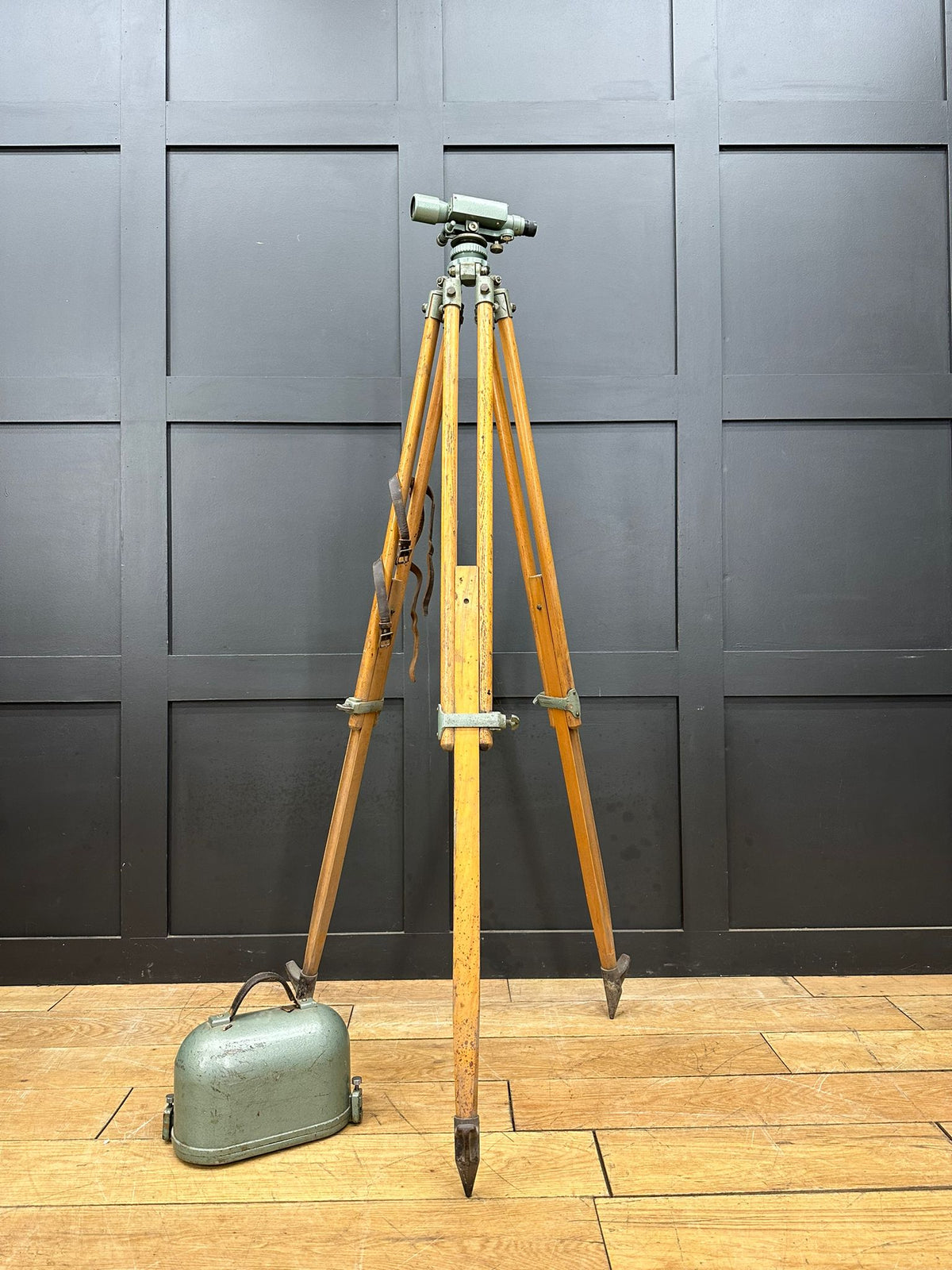 Vintage hall brothers theodolite mounted on wooden tripod with green metal carrying case for surveying use