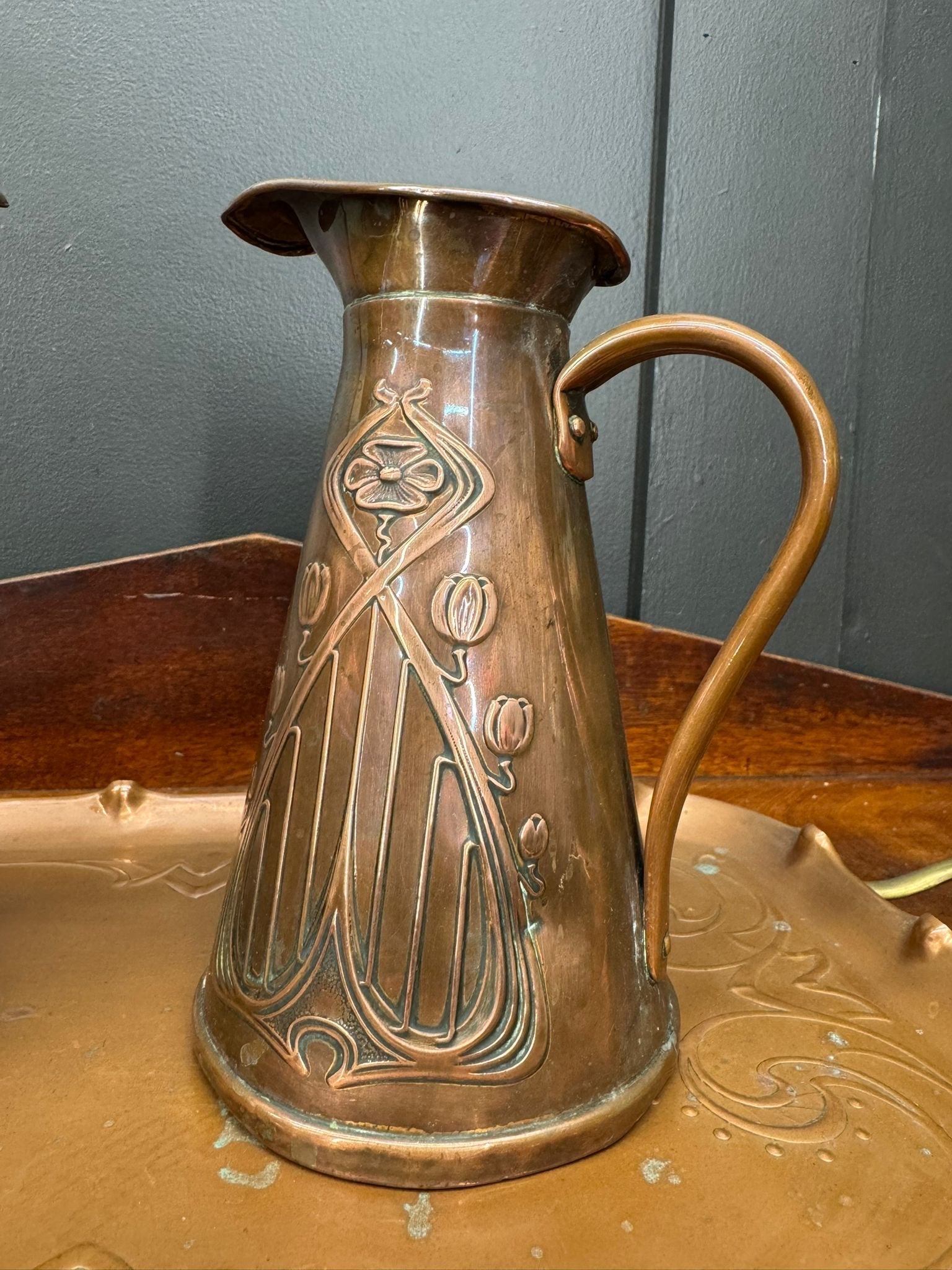 Antique joseph sankey copper pitcher with art nouveau floral and leaf embossing and curved handle features