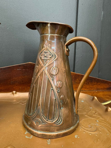 Antique joseph sankey copper pitcher with art nouveau floral and leaf embossing and curved handle features