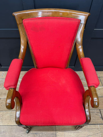 Antique mahogany armchair with polished wooden frame and vibrant red upholstered seat and backrest vintage style