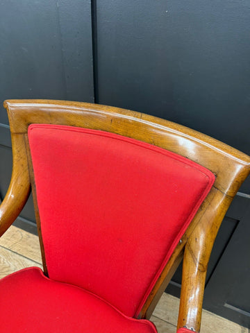 Vintage-style antique mahogany armchair with polished wooden frame and vibrant red upholstered seat and backrest