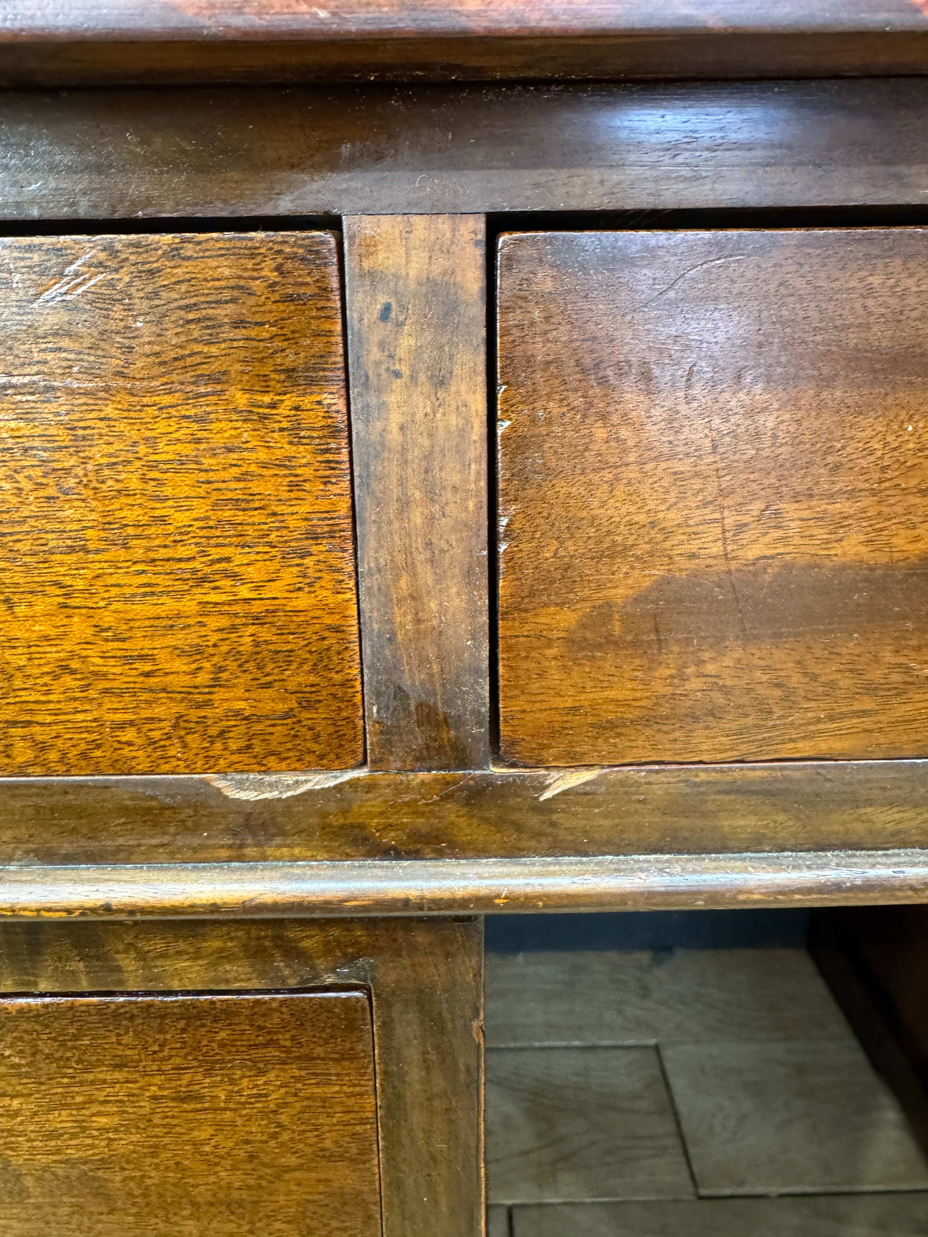 Dark brown antique mahogany twin pedestal desk with two drawers and worn wood grain finish for office use