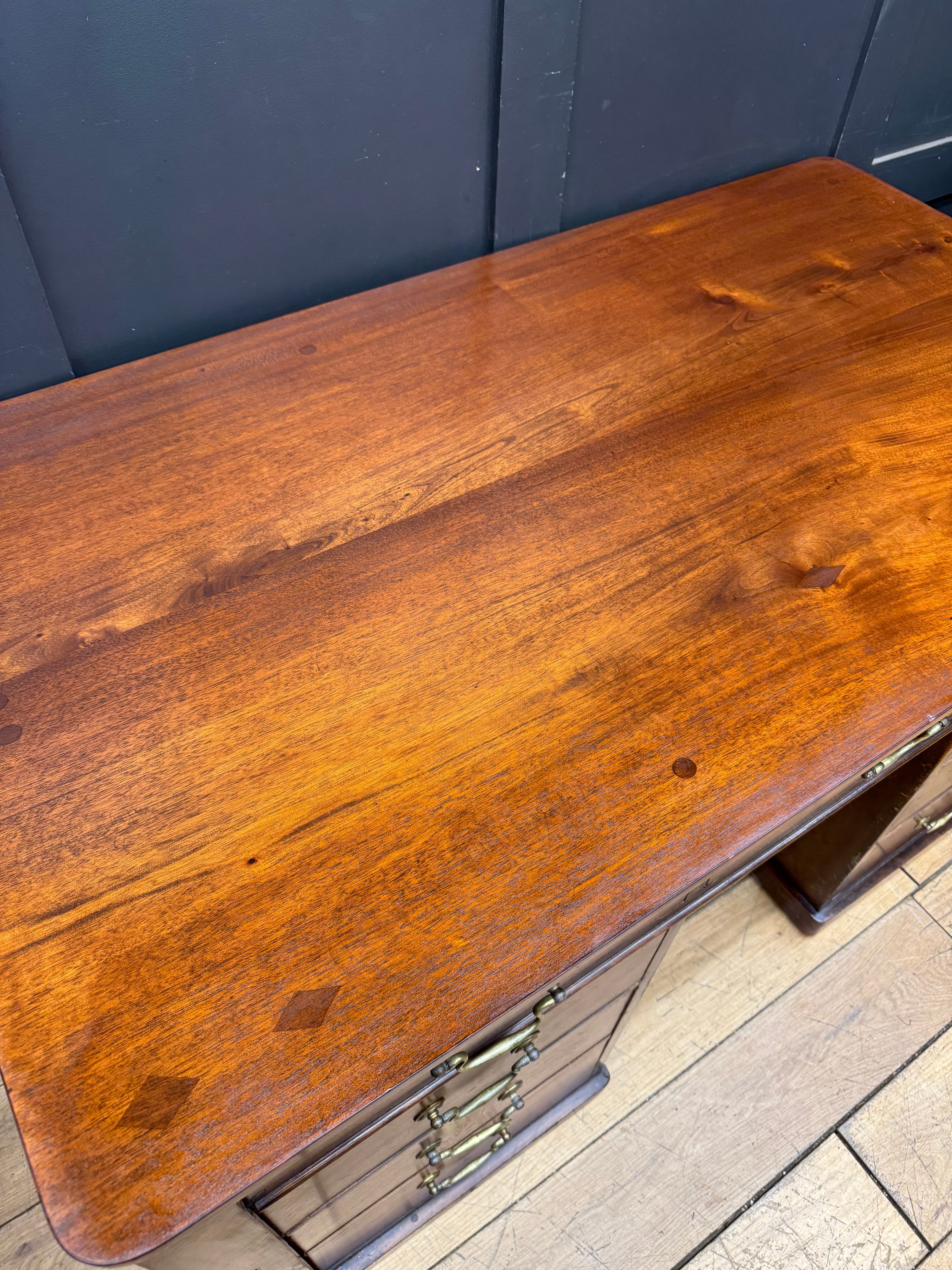 Antique mahogany twin pedestal kneehole desk with rich warm wood finish and brass hardware for office or writing use