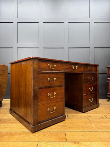Antique mahogany twin pedestal desk with brass handles and polished wood top ideal for writing or office use