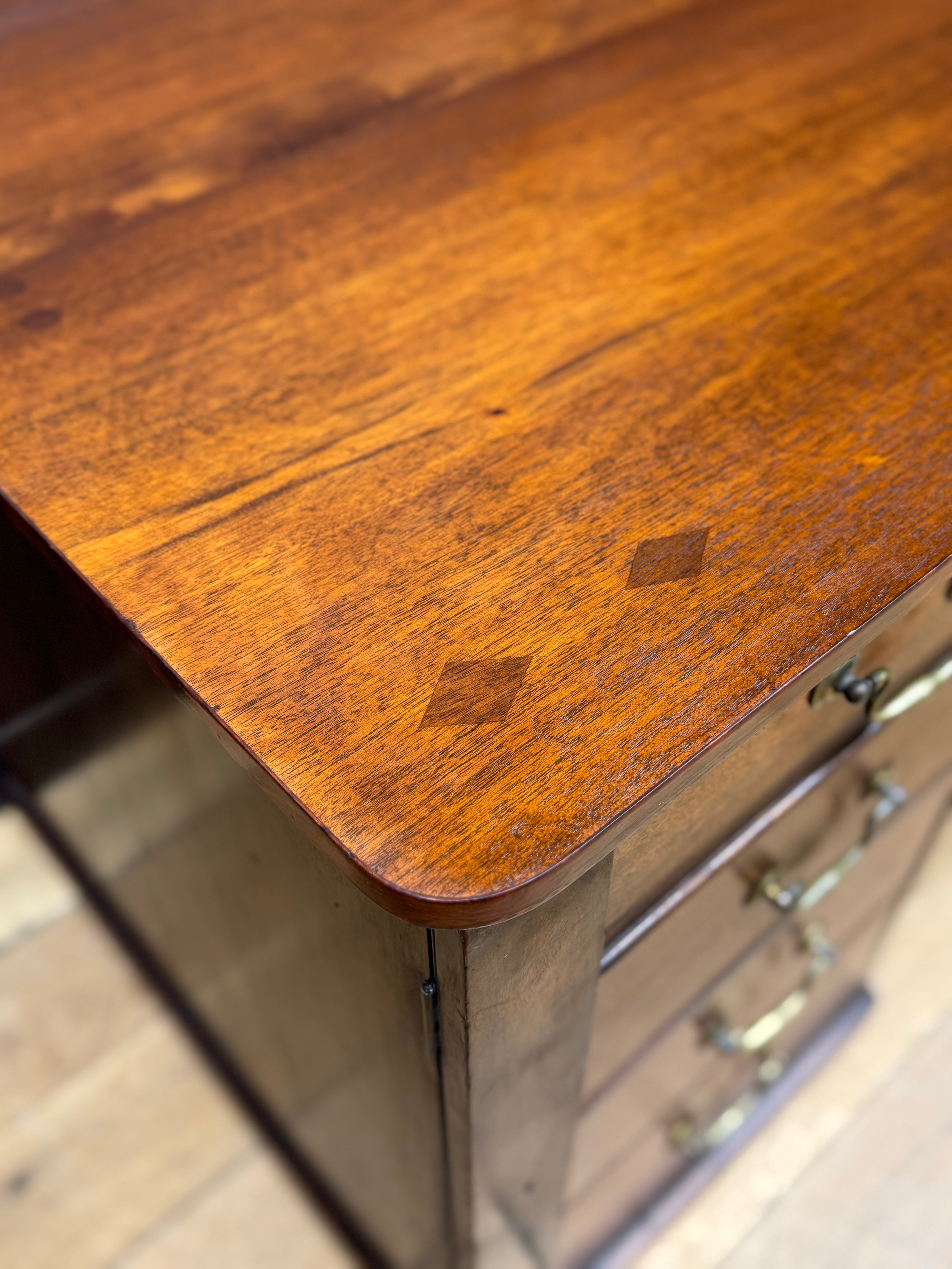 Antique mahogany twin pedestal desk with rich amber finish and subtle diamond inlay perfect for office use