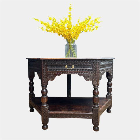 Dark wood oak credence table with intricate carvings and a single drawer featuring brass handles perfect as a sideboard