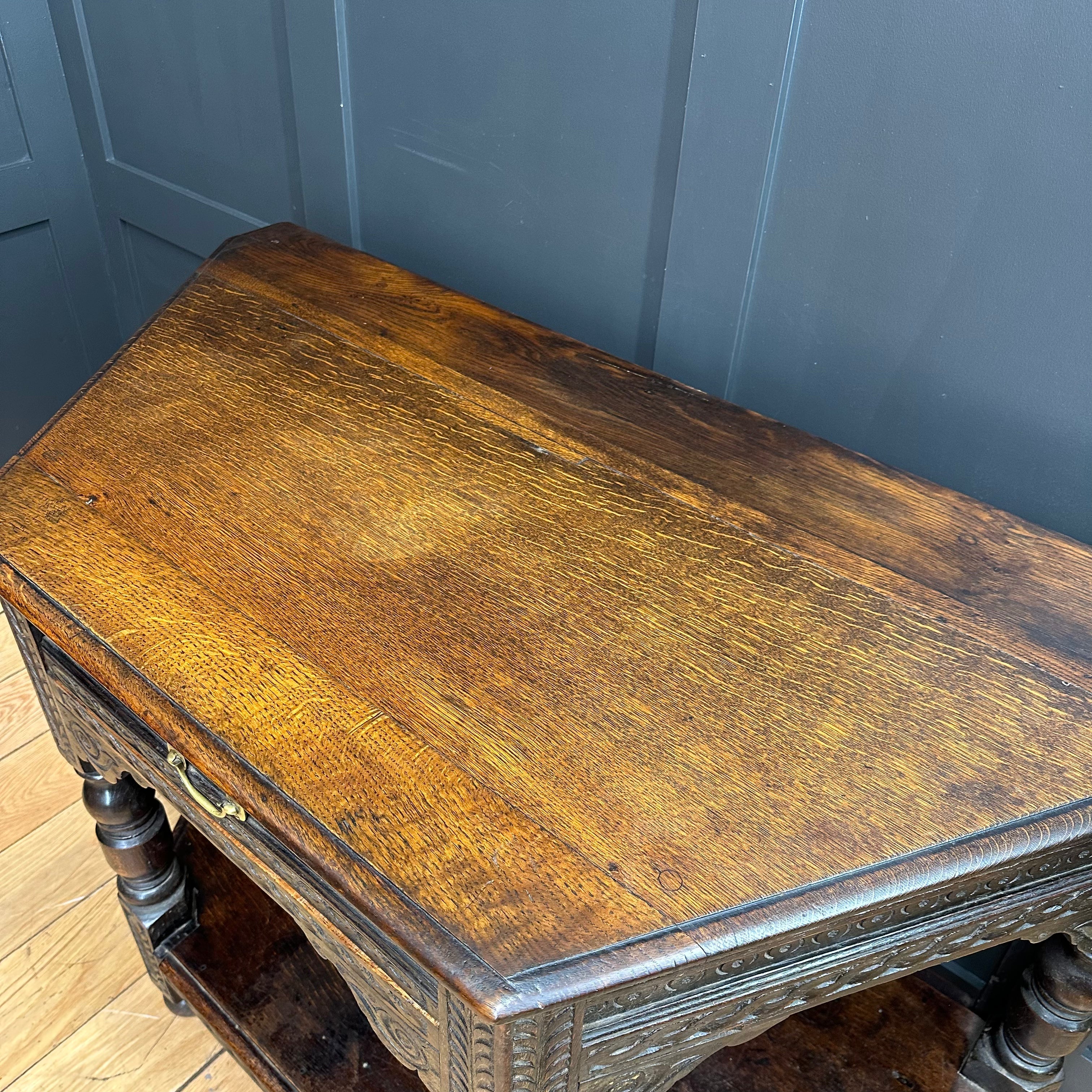 Antique oak credence table with warm brown finish and intricate carved details perfect as a sideboard or lamp table