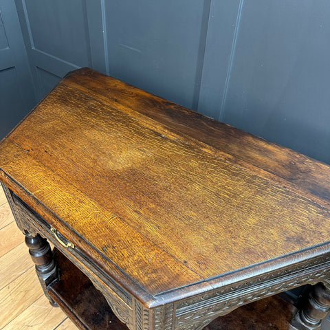 Antique oak credence table with warm brown finish and intricate carved details perfect as a sideboard or lamp table