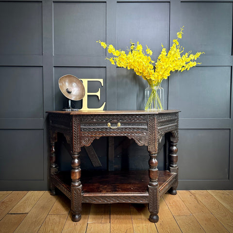 Dark wood oak credence table with intricate carvings and a single drawer with brass handles perfect as a sideboard
