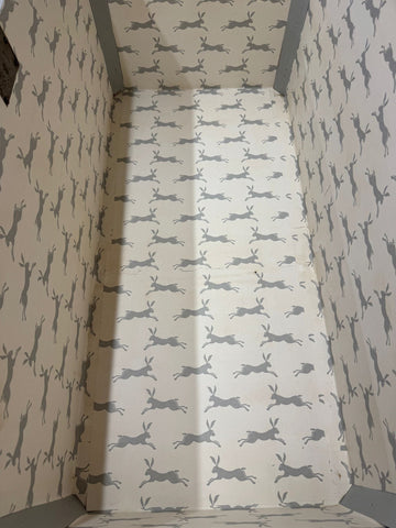 Antique painted blanket chest lined with cream wallpaper featuring gray hares ideal for shoe storage or toy bench